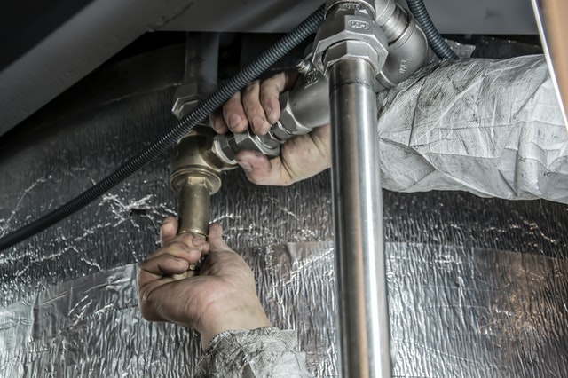 plumber fixing sink