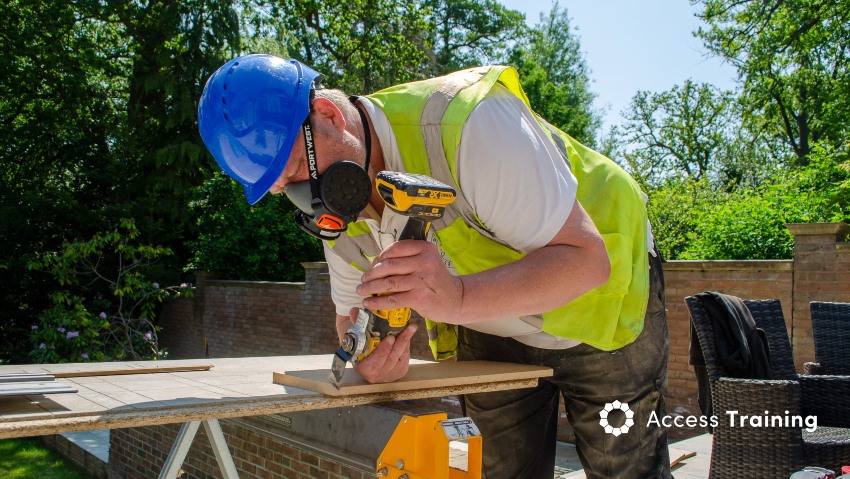 Photo of a tradesman cutting through a piece of wood