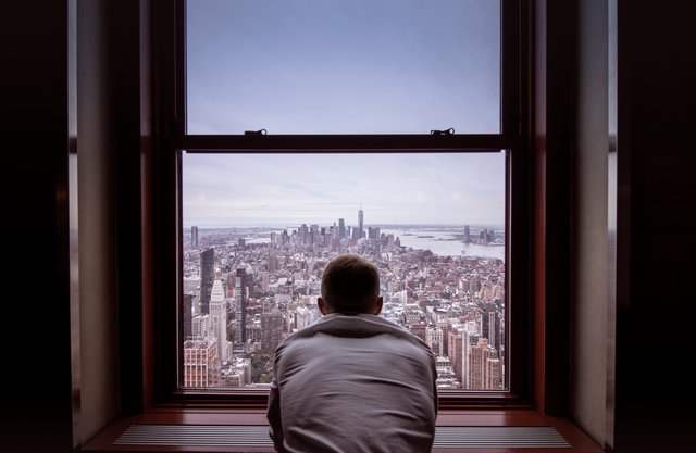 Man looking out his window