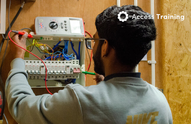 An electrician working on electrical equipment